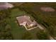 Aerial view of a charming single-Gathering home with a large yard, pool, and waterfront access at 8223 Snowy Egret Pl, Bradenton, FL 34202