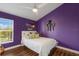 Bright bedroom with a ceiling fan, a decorative wall shelf, and a large window at 8223 Snowy Egret Pl, Bradenton, FL 34202