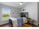 Well-lit bedroom with a large window providing natural light and comfortable furnishings at 8223 Snowy Egret Pl, Bradenton, FL 34202