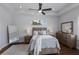 Comfortable bedroom with a ceiling fan, plush bedding, bedside tables with lamps and dresser at 8223 Snowy Egret Pl, Bradenton, FL 34202