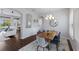 Dining room featuring a wooden table, blue chairs, and modern chandelier at 8223 Snowy Egret Pl, Bradenton, FL 34202