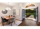 Sunlit dining room boasts a modern chandelier, wood floors, and an open entryway at 8223 Snowy Egret Pl, Bradenton, FL 34202
