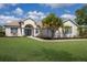 Lovely home featuring a spacious lawn, decorative landscaping, and a welcoming entrance at 8223 Snowy Egret Pl, Bradenton, FL 34202