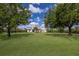 Charming single-story home with a sprawling green lawn, mature trees, and inviting curb appeal at 8223 Snowy Egret Pl, Bradenton, FL 34202