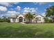 Inviting front exterior showcasing a well-manicured lawn and beautiful landscaping at 8223 Snowy Egret Pl, Bradenton, FL 34202