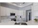 Modern kitchen featuring white cabinetry, stainless steel appliances, and luxurious countertops at 8223 Snowy Egret Pl, Bradenton, FL 34202