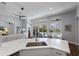 Open concept kitchen with quartz counters, stainless steel appliances, island sink, and views to living spaces at 8223 Snowy Egret Pl, Bradenton, FL 34202