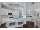 Modern kitchen featuring white cabinetry, stainless steel appliances, and a convenient breakfast bar at 8223 Snowy Egret Pl, Bradenton, FL 34202