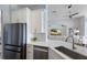 Modern kitchen with white cabinets, stainless steel appliances, and granite countertops at 8223 Snowy Egret Pl, Bradenton, FL 34202