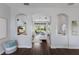 Open concept living spaces with hardwood flooring, arched doorways, and seamless flow throughout the home at 8223 Snowy Egret Pl, Bradenton, FL 34202
