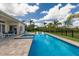 Backyard pool featuring spa, lounge chairs and lush landscaping, perfect for relaxation and entertaining at 8223 Snowy Egret Pl, Bradenton, FL 34202