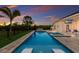 Sparkling pool with spa features in-pool seating and an outdoor television for entertainment at 8223 Snowy Egret Pl, Bradenton, FL 34202