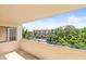 Relaxing balcony space overlooking mature trees, with a view of the neighborhood pool at 825 S Osprey Ave # 302, Sarasota, FL 34236