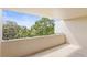 Open-air balcony with a serene view of lush greenery and a blue sky at 825 S Osprey Ave # 302, Sarasota, FL 34236