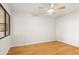 Bright bedroom with hardwood floors, ceiling fan, and window offering ample natural light at 825 S Osprey Ave # 302, Sarasota, FL 34236