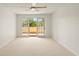 Spacious bedroom with ceiling fan and access to a private balcony at 825 S Osprey Ave # 302, Sarasota, FL 34236