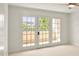 Light-filled bedroom with patio doors to outdoor terrace at 825 S Osprey Ave # 302, Sarasota, FL 34236