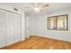 Well-lit bedroom with closet space, ceiling fan, and hardwood floors at 825 S Osprey Ave # 302, Sarasota, FL 34236