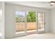 Bright bedroom featuring sliding doors to a sunny private balcony at 825 S Osprey Ave # 302, Sarasota, FL 34236