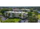 Beautiful condominiums featuring multiple stories, lush landscaping, and a serene lakeside setting at 825 S Osprey Ave # 302, Sarasota, FL 34236