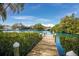 Scenic view of a wooden dock leading to calm waters, surrounded by lush greenery at 825 S Osprey Ave # 302, Sarasota, FL 34236