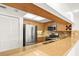 Kitchen bar with stone countertops looks out over stainless steel appliances and wood cabinetry at 825 S Osprey Ave # 302, Sarasota, FL 34236