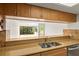 Eat-in kitchen features stone countertops, stainless steel sink, and a view to the living room at 825 S Osprey Ave # 302, Sarasota, FL 34236