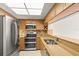 Eat-in kitchen with stainless steel appliances, wood cabinetry, and natural light at 825 S Osprey Ave # 302, Sarasota, FL 34236