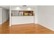 Open-concept living room with bar top to kitchen, hardwood floors, and natural light at 825 S Osprey Ave # 302, Sarasota, FL 34236