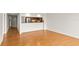 Bright living room with hardwood floors and view into the open kitchen with stainless appliances at 825 S Osprey Ave # 302, Sarasota, FL 34236