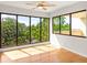 Light-filled living room featuring hardwood floors, large windows, and views of mature trees at 825 S Osprey Ave # 302, Sarasota, FL 34236
