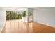 Bright living room featuring hardwood floors, large windows, and a door to the balcony at 825 S Osprey Ave # 302, Sarasota, FL 34236