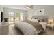 Well-lit main bedroom featuring patio doors, neutral paint and carpet, and modern furnishings at 825 S Osprey Ave # 302, Sarasota, FL 34236
