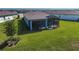 A spacious backyard featuring a screened lanai with seating, perfect for outdoor living and relaxation at 8313 Ocean Tides Cv, Parrish, FL 34219