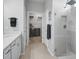 Bright bathroom with walk-in shower and closet access, enhanced with modern tile flooring at 8313 Ocean Tides Cv, Parrish, FL 34219