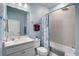 Stylish bathroom with a vanity, decorative mirror, and shower-tub combination at 8313 Ocean Tides Cv, Parrish, FL 34219