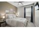 Cozy bedroom features a ceiling fan, a comfortable queen-size bed, and ample natural light at 8313 Ocean Tides Cv, Parrish, FL 34219