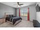 Comfortable bedroom features a ceiling fan, a window with blinds, and an entertainment center at 8313 Ocean Tides Cv, Parrish, FL 34219