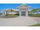 Elegant clubhouse entrance with manicured landscaping and covered entry, offering a welcoming atmosphere at 8313 Ocean Tides Cv, Parrish, FL 34219