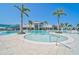 Stunning community pool area with lush landscaping and resort-style amenities under a bright blue sky at 8313 Ocean Tides Cv, Parrish, FL 34219