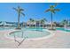 Inviting community pool featuring a shallow area and ample lounge seating for relaxation at 8313 Ocean Tides Cv, Parrish, FL 34219