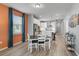 Open dining space showcasing hardwood floors, modern decor, and seamless flow to kitchen at 8313 Ocean Tides Cv, Parrish, FL 34219
