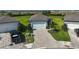 Aerial view of a well-manicured front yard with a paver driveway leading to a two-car garage at 8313 Ocean Tides Cv, Parrish, FL 34219