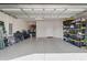 Spacious garage with epoxy flooring and ample storage, perfect for vehicles and hobbies at 8313 Ocean Tides Cv, Parrish, FL 34219