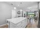Open concept kitchen, dining and living area with hardwood floors and a breakfast bar at 8313 Ocean Tides Cv, Parrish, FL 34219