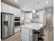 Modern kitchen featuring stainless steel appliances, white cabinets, and a center island with seating at 8313 Ocean Tides Cv, Parrish, FL 34219