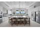 Open kitchen features a large island with seating, modern appliances, and stylish pendant lighting at 8313 Ocean Tides Cv, Parrish, FL 34219