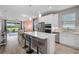 Well-lit kitchen featuring a large island, stainless steel appliances, and view into the dining/living area at 8313 Ocean Tides Cv, Parrish, FL 34219