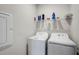 Functional laundry room equipped with a washer, dryer, and ample shelving for storage at 8313 Ocean Tides Cv, Parrish, FL 34219