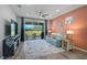 Relaxing living area with a plush sofa, entertainment center, and sliding doors to the backyard at 8313 Ocean Tides Cv, Parrish, FL 34219